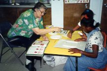 Photo: building a sugar cube pyramid with foster grandparent volunteer