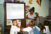 Photo: study skills group learning to count money with resident volunteer