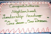 Photo of cake which reads: Congratulations Neighborhood Leadership Academy "One Team, One Dream"