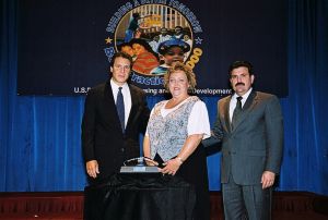 Photo of Cinda Hayward receiving award from Secretary Cuomo & Deputy Secretary Ramirez 