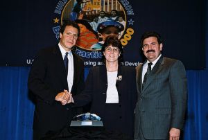 Photo of Karen Speakman receiving award from Secretary Cuomo & Deputy Secretary Ramirez