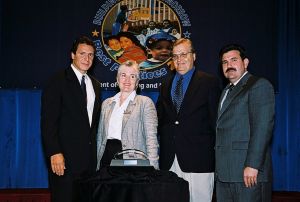 Photo of Cathy Buggs & Tom Cusack receiving award from Secretary Cuomo & Deputy Secretary Ramirez