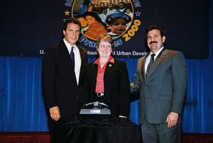 Photo of Janet Cook receiving award from Secretary Cuomo and Deputy Secretary Ramirez