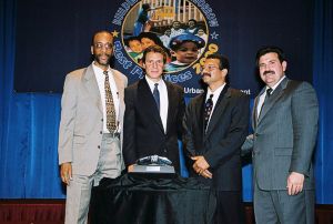 Photo of Dr. Epsilon Omer and William Jameson receiving award from Secretary Cuomo & Deputy Secretary Ramirez