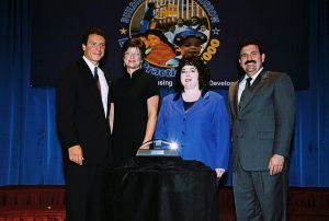 Photo of Allison Cardell and Susan Budrah receiving award from Secretary Cuomo & Deputy Secretary Ramirez