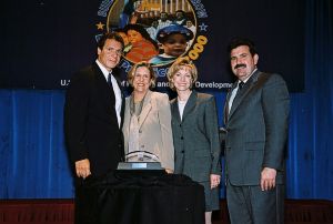 Photo of Nancy Crane & Karen Nepenski receiving award from Secretary Cuomo & Deputy Secretary Ramirez