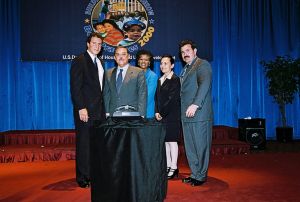 Photo of Carolos Jackson, Berdette Glover and Maria Badrakhan receiving award from Secretary Cuomo & Deputy Secretary Ramirez