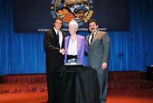 Photo of Patricia Crowley receiving award from Secretary Cuomo & Deputy Secretary Ramirez