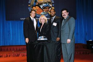 Photo of Glenda Kirkland and Richard Green receiving award from Secretary Cuomo & Deputy Secretary Ramirez