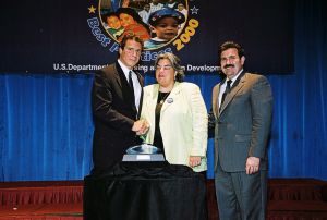 Photo of Jacquelyne Lusardi receiving award from Secretary Cuomo & Deputy Secretary Ramirez