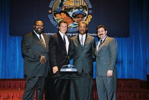 Photo of Charlie Smith & James Tabron receiving award from Secretary Cuomo & Deputy Secretary Ramirez