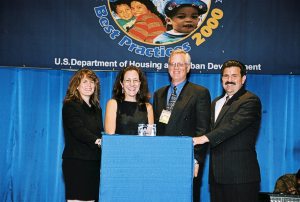 Charlene Dwyer (Center-L) Receiving Simply the Best Award