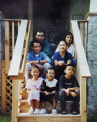 [Photo 1:  The new homeowner, Poeim Chhil and family in front of their new house]