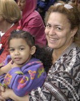 [Photo 2: New homeowner Luisa Lee and her daughter]