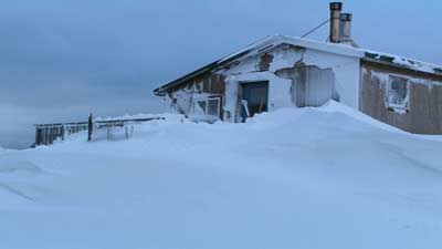 [Photo: Snowbound house]