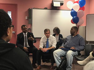 [Officials participate in the roundtable discussion]