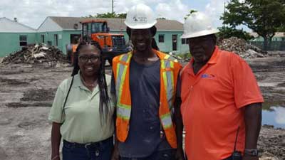 [Lola Capers from RUNU Construction, with graduates from Employ Miami-Dade, and her new hires, Henry Farmer and Steve Lucien.]