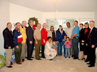 [Photo 2: Picture of the Armour family and some of the people that made the new house possible]
