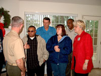 [Photo 1: Picture of COL David Barraclough (USMC) congratulating the Armour family]