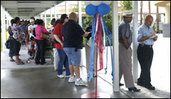 [Photo of the line of people coming to the fair under the walkway canopy, with the end of the line out of sight.]