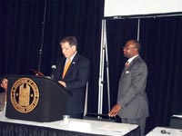 [Photo 1: Bob Young and Johnny Dupree at Podium]