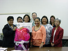 [Photo: Group of people smiling with new home buyer]