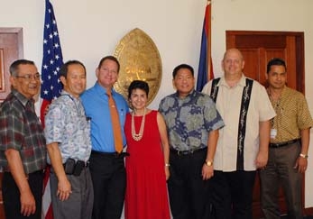 [Photo 3: Left to right: Roque Mendiola, Mike Flores, Acting Governor Ray Tenorio, Ophelia Basgal, Ryan Okahara, Mark Chandler and Ray Topasna]