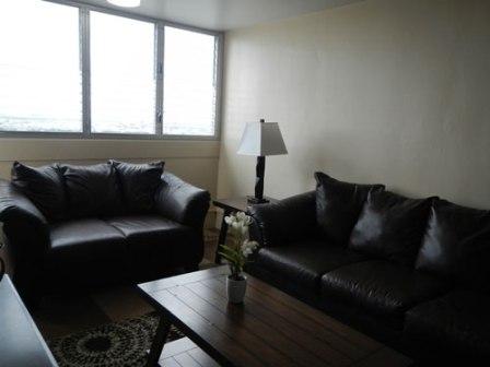 [Photo 3: Living room of model apartment available at the newly renovated Towers at Kuhio Park.]