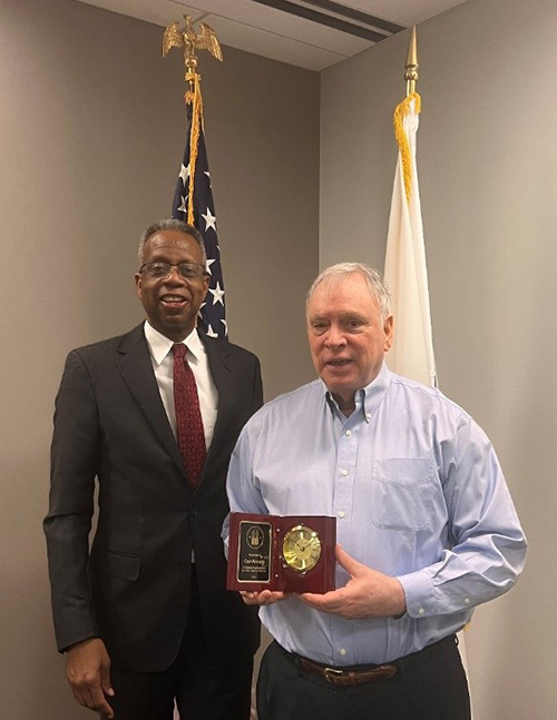 [(L-R) Great Plains Regional Administrator, Ulysses 'Deke' Clayborn poses with Financial Analyst, Carl Rhoads to celebrate his 37 years of service.]