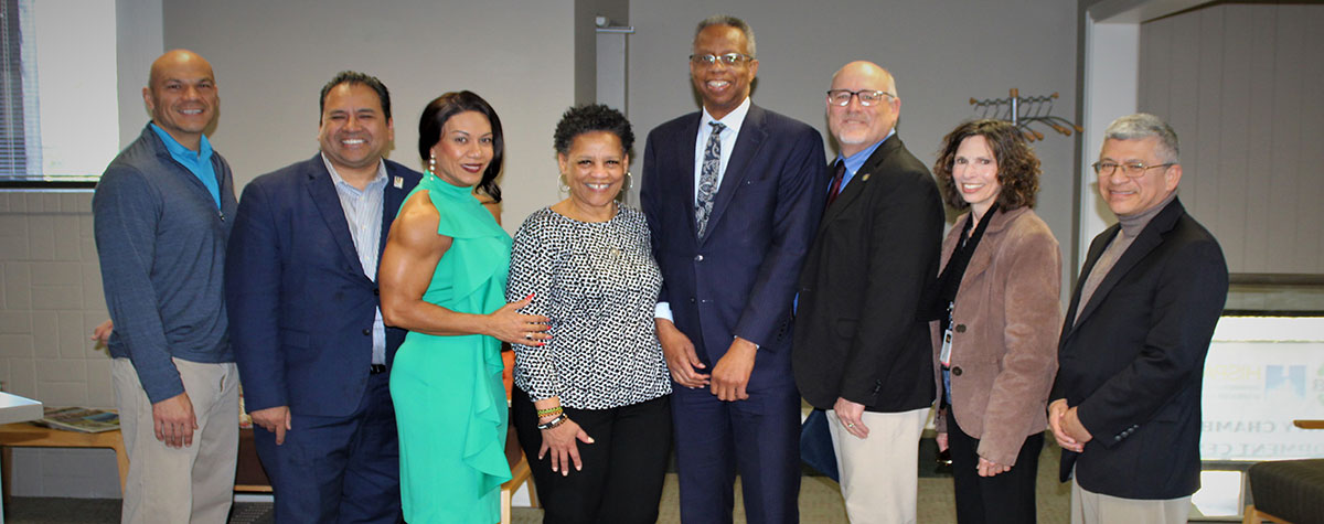 [(L-R) Hispanic Chamber Board Chair Santos Madrigal, Hispanic Chamber President/CEO Carlos Gomez, Hispanic Chamber Board Member Helen Ortiz, Heartland Black Chamber President/CEO Kim Randolph, HUD Great Plains Regional Administrator Ulysses Clayborn, HUD Great Plains Deputy Regional Administrator Bruce Ladd, HUD Great Plains Regional Environmental Officer Beth Held, and HUD Great Plains Kansas/Western Missouri Field Office Director Jose Davis gather at the new Minority Chamber of Commerce Development Center at 9100 Ward Parkway in Kansas City, Missouri made possible by $4 million in congressional Community Project Funding, on Wednesday, March 20, 2024.  (Photo credit: HUD Great Plains)]