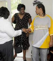Alysia Wilson and Yolanda Gilyard are greeted by homeowner John Glenn during an open house Wednesday morning.