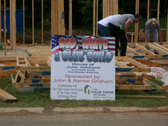 Photo 3: Volunteers building a house.