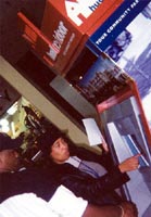 [Photo: Teresa Stovall, Operations Analyst, demonstrates the use of the touch screen on the HUD Kiosk at The Plaza in Northwest Baltimore]