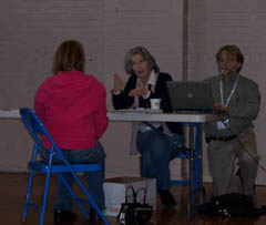 [Photo: Tax volunteers with client]