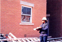 [Photo: Tara checking for broken windows]