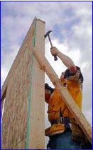 [Photo 6: Youthbuild wall raising]