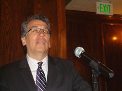 [Photo 1: Regional Administrator Rick Garcia speaks to audience]