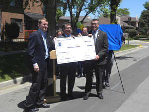[Photo 2: Left to right -Michael Bennet, Rick Garcia and Ismael Guerrero display check]