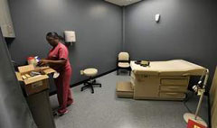 [Photo 2: Coco Thomas organizes supplies. / Jeanne Reasonover / The Tennessean]