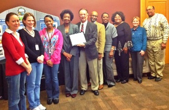 [Photo: Ed Eillis, HUD Field Office Director, Knoxville (center of photo) presents an award to Beverly Johnson, Chattanooga Community Development Director along with her staff.]
