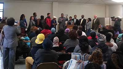 [Photo: HUD SE Regional Administrator Jennings shows Foot Home families the new ConnectHome smart tablets which will allow them to access the internet]