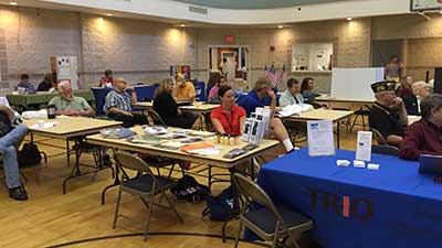 [Photo 2: Service providers listening intently to the program announcements]