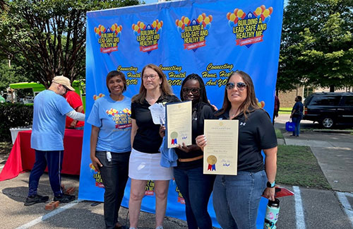[Cheryl Marsh, Memphis Housing Navigator (left) and Ruth Ann Norton, Chief Executive Officer (second from left) of the Green and Healthy Homes Initiative present Yolanda Brown and Michelle Miller of the Office of Lead Hazards Control and Healthy Homes a Proclamation signed by Tennessee Governor Bill Lee highlighting June as Healthy Homes Month in Tennessee.  The Proclamation was presented at the HUD 'Building a Lead-Safe and Healthy Me' outreach event on June 17 in Memphis, Tennessee.]
