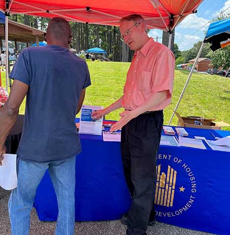 [Memphis Field Office Director Walter Perry (right) informs a Lincoln Courts resident about benefits of the Affordable Connectivity Program during HUD's outreach in Jackson, Tennessee at the Jackson Housing Authority's 2023 Family Empowerment Expo.]
