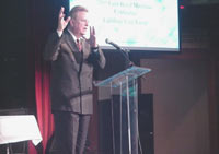 [Photo 1: Pastor Paul Russell at the podium]