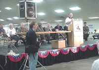 [Photo 1: Bill Burleigh at the podium]