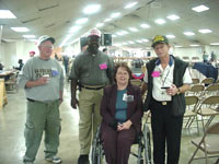 [Photo 4: HUD official and three veterans]