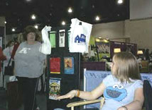 [Photo 4: Visitor looks at HUD brochures]