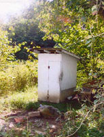 [Photo 1: Original outhouse]