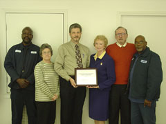 [Photo 2: Ms. Leander presents STAR Award to Milan Housing Authority Executive Director and staff]